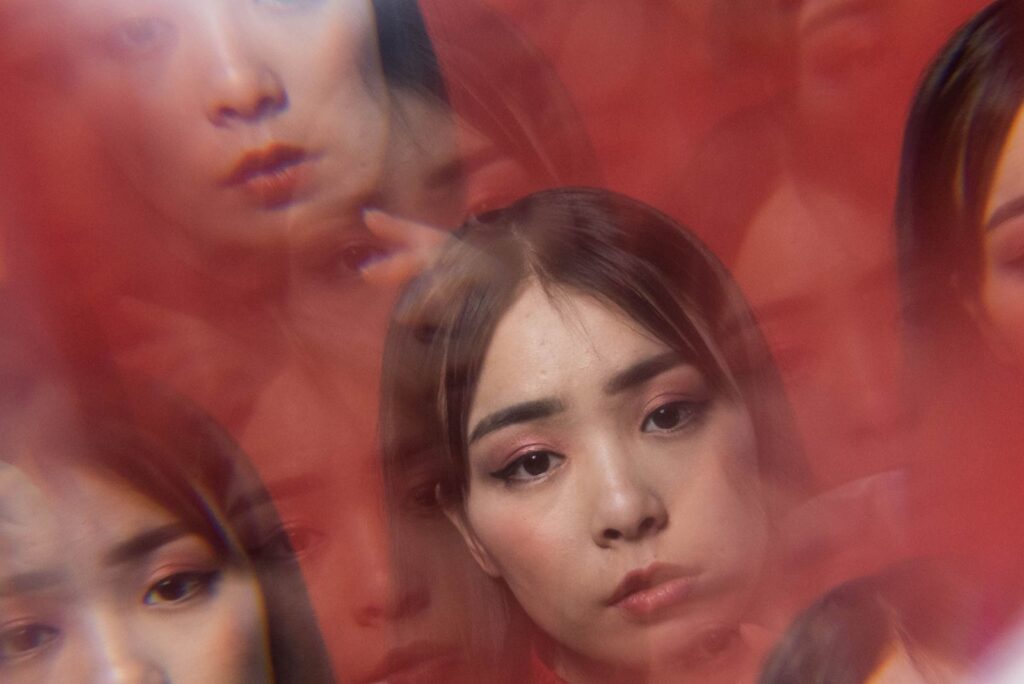 a photograph of a young asian woman with a kaleidoscope effect